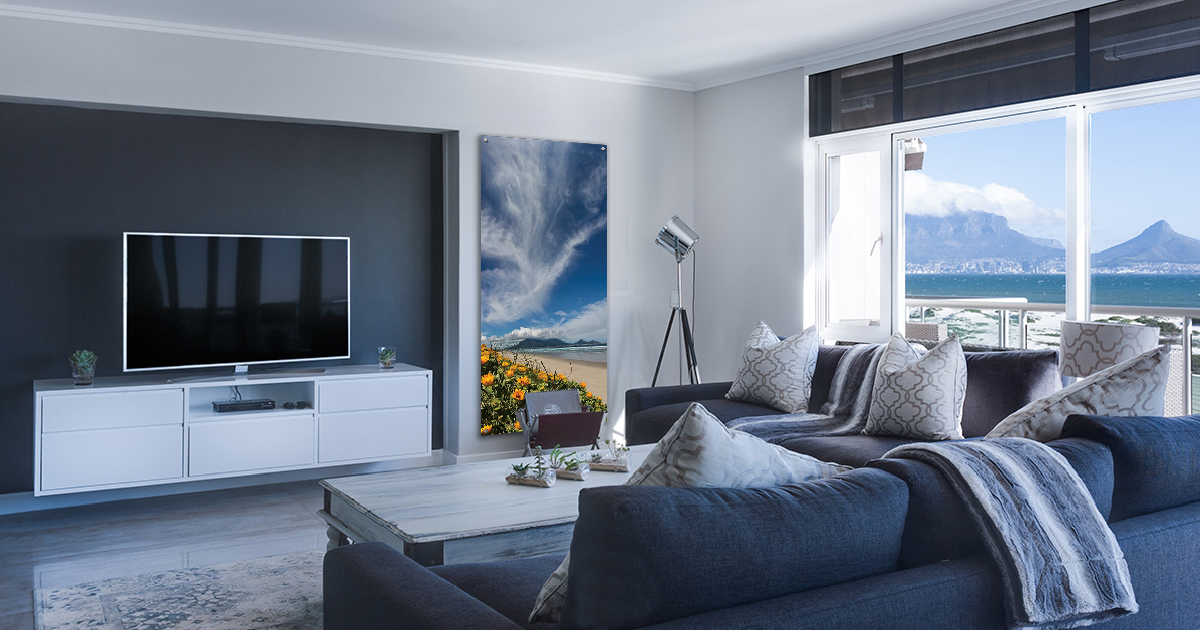 The Bay: A Table Bay vertical print with Table Mountain in view, shot from Milnerton Beach. Yellow vygies bloom under a wispy sky. Limited edition, on canvas or matt paper, 525mm x 1250mm.